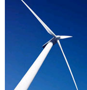 image of a wind turbine set against a bright blue sky