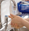 Washing hands under a running tap Image of British Gas boiler
