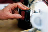 British Gas Homecare Flexi; man turning on a steel kettle