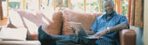 image of a man relaxing on a sofa