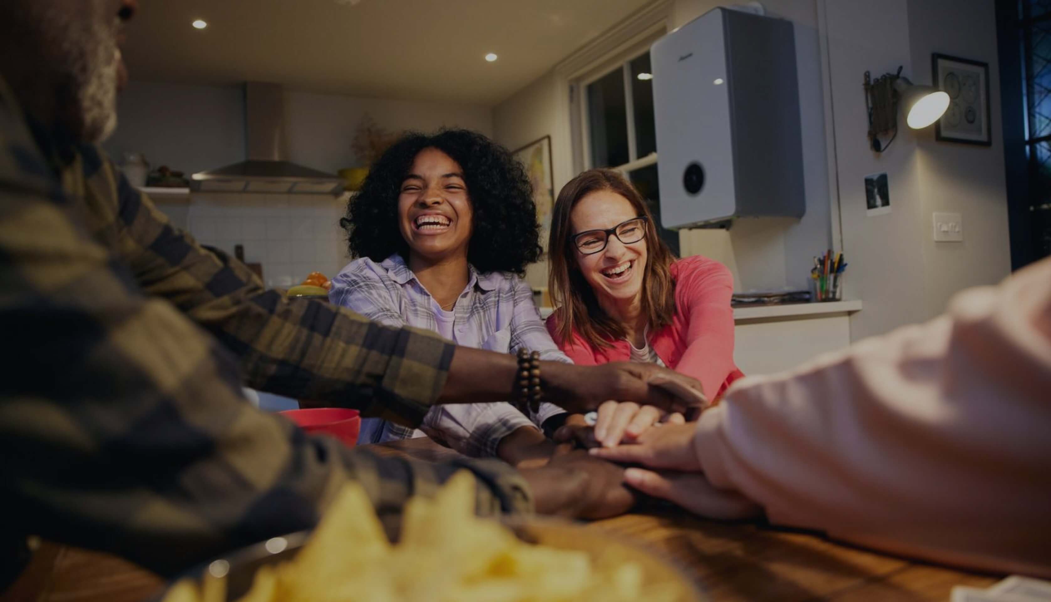 A family around the dining room table in their smart home.