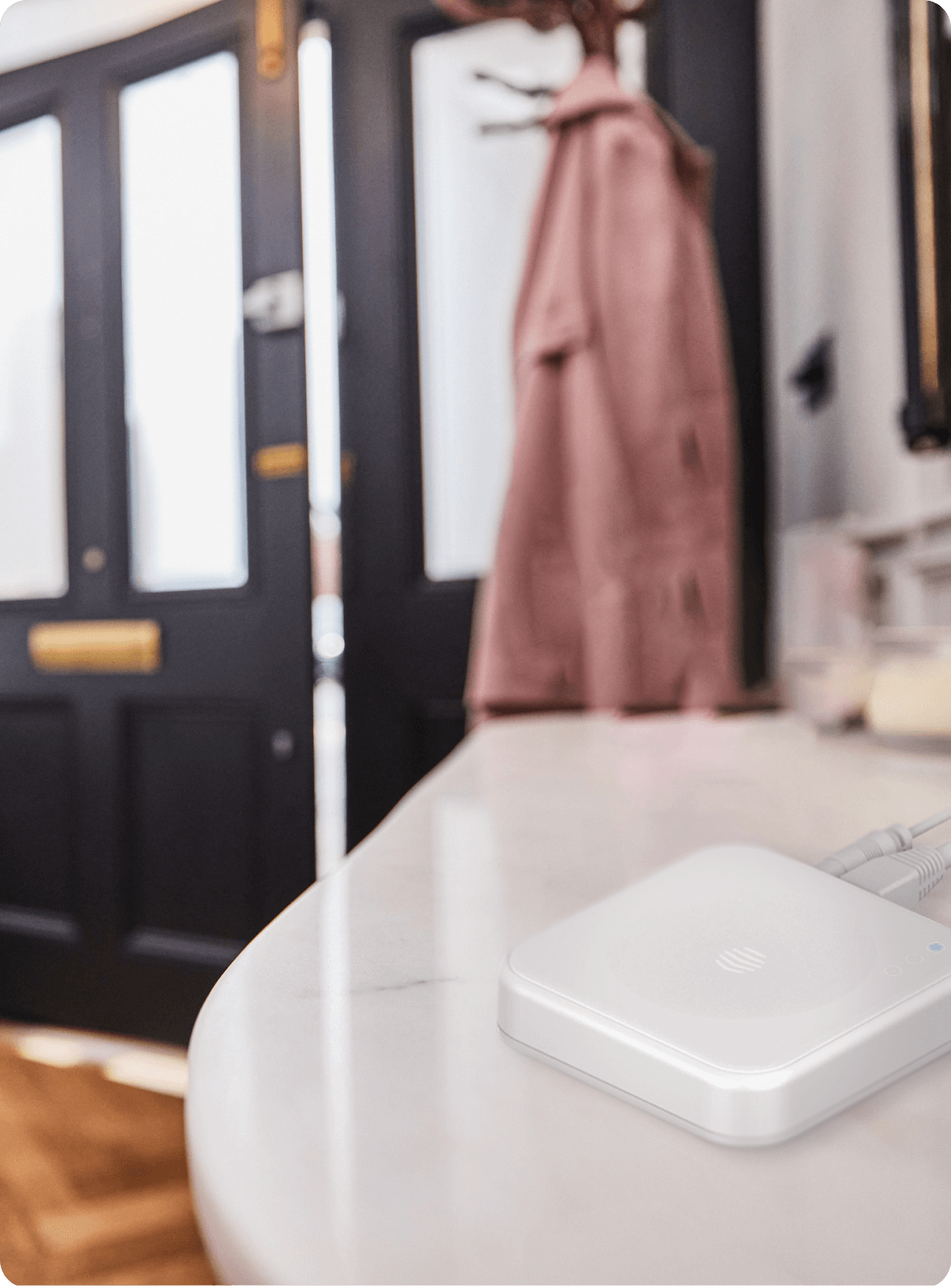 A Hive Hub placed in a hallway inside a smart home.